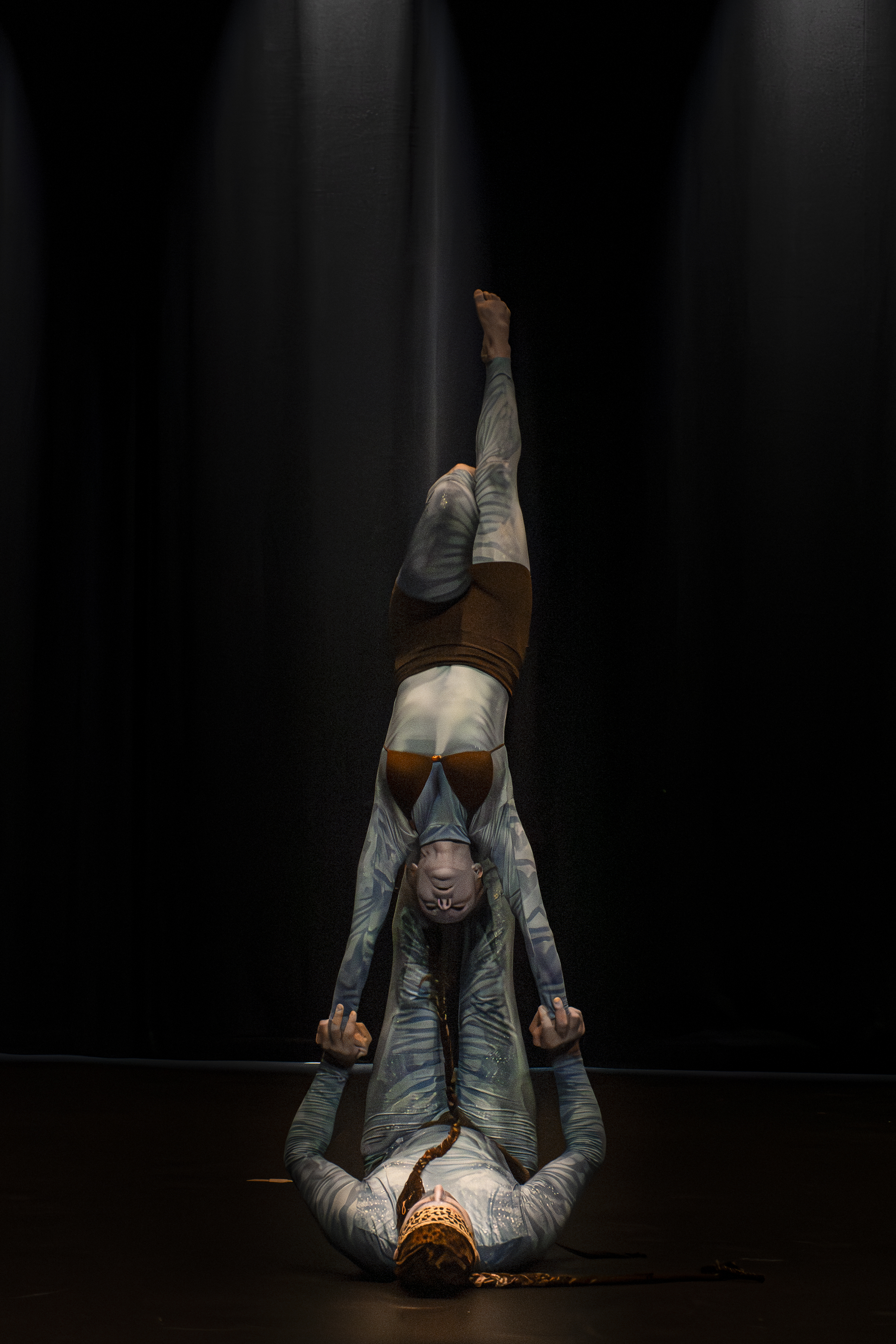 Partner acrobats performing a human tower on the beach